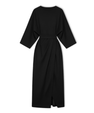 Long women's dress with batwing sleeves and a fitted waist, flowing silhouette